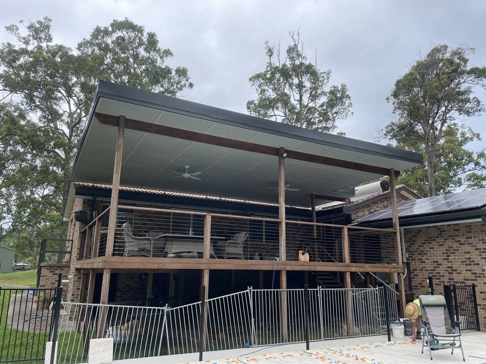 Large covered deck with a skillion roof behind a pool fence
