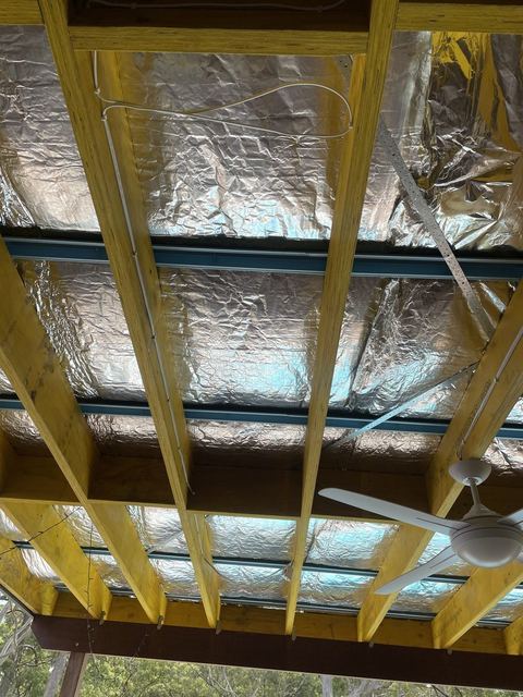 Pergola roof frame with insulation going on under the sheets